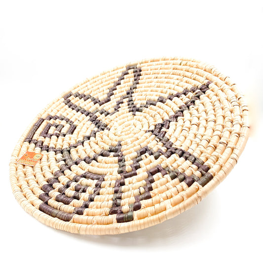 Handwoven butterfly plate in palm