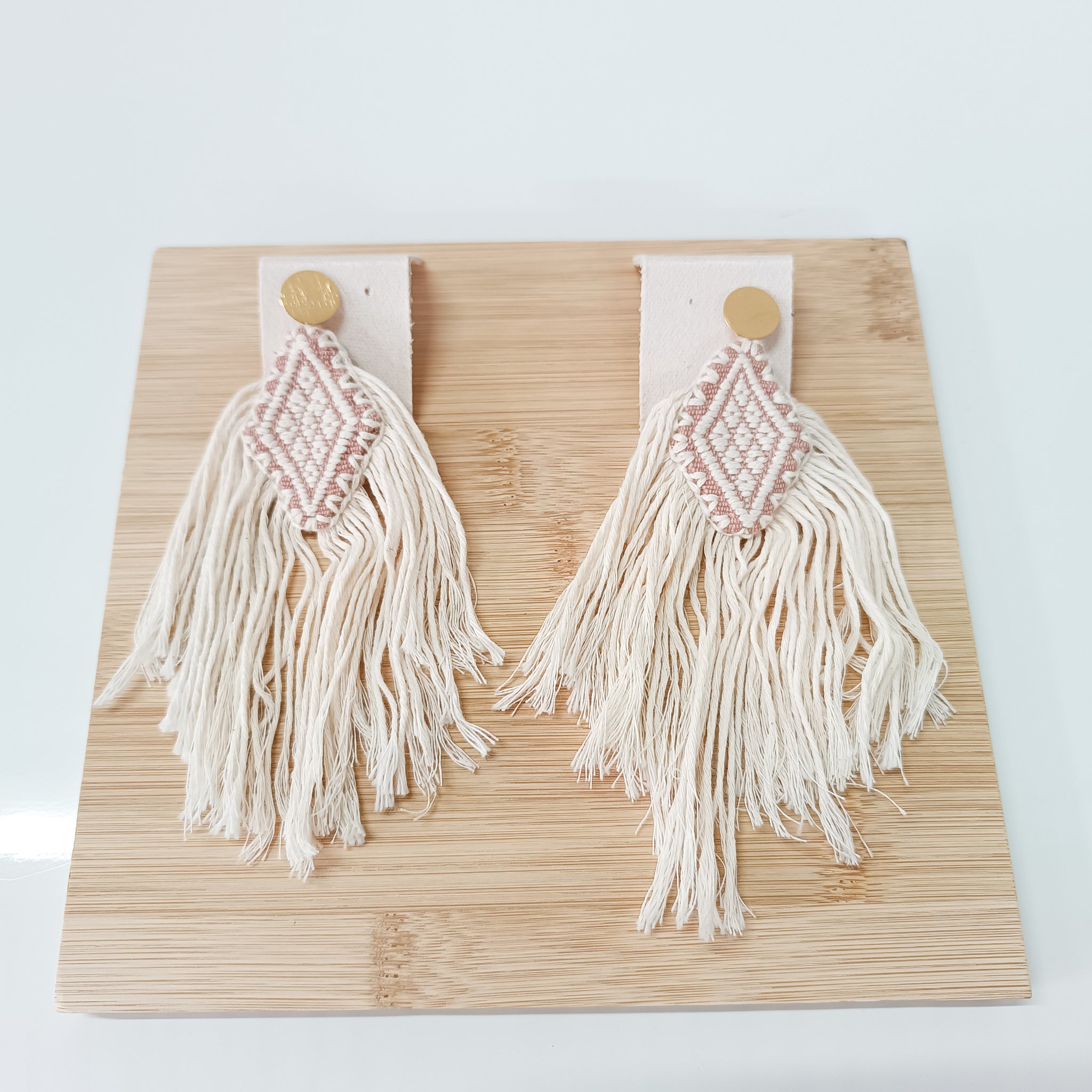 Diamond earrings woven on a backstrap loom with fringes