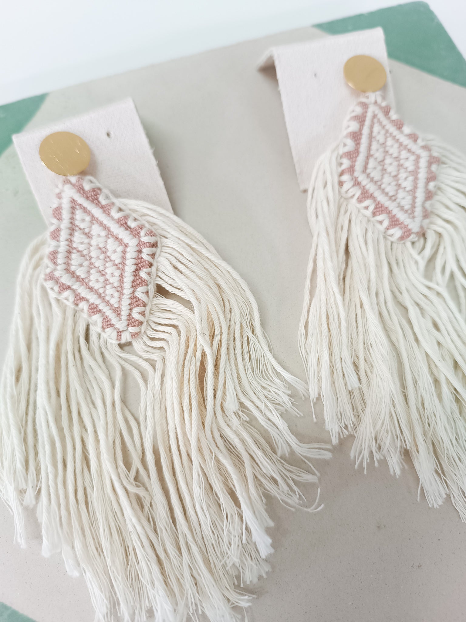 Diamond earrings woven on a backstrap loom with fringes