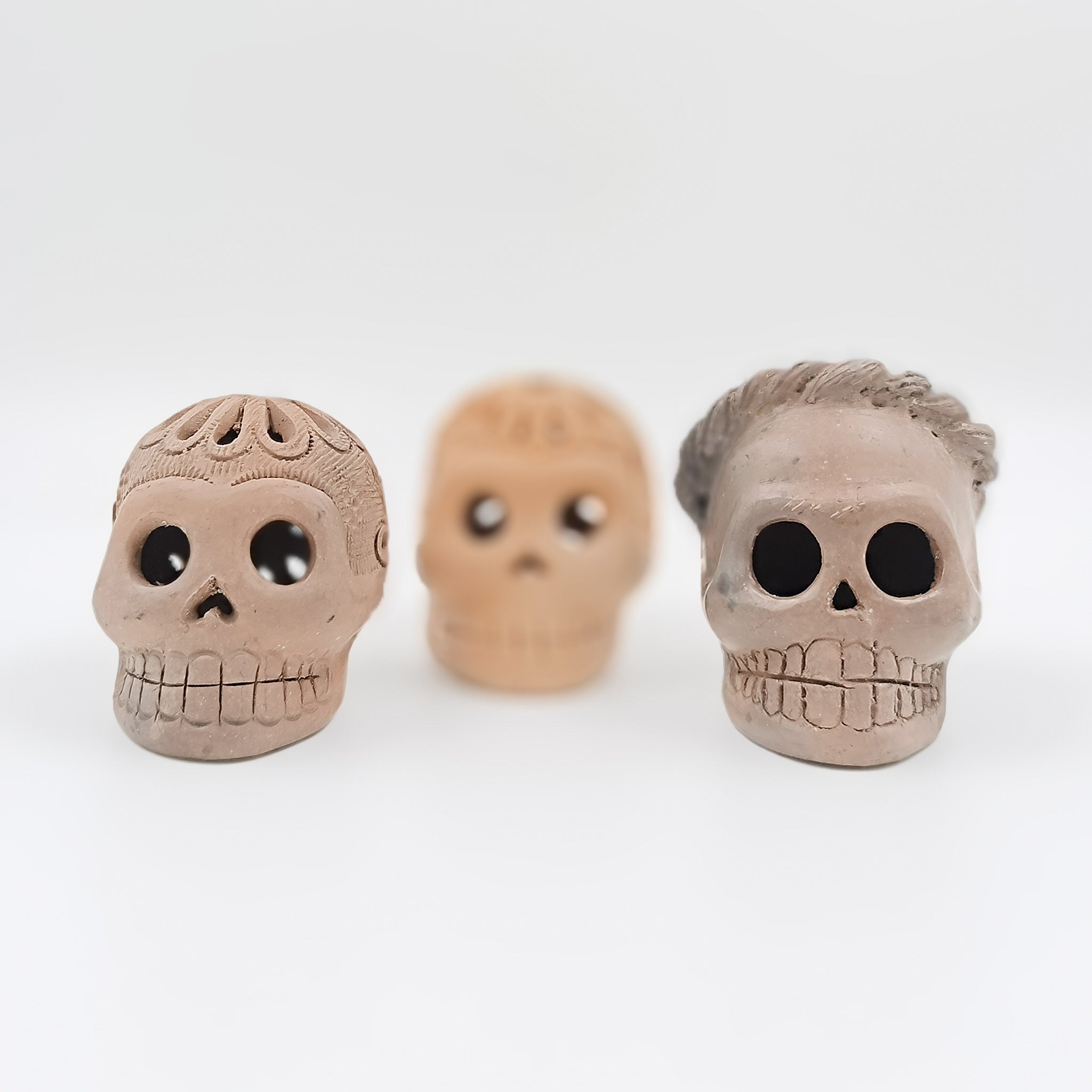 Cráneos de calaverita en barro negro