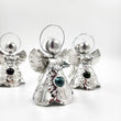 Angelitos de hojalata con canica de vidrio