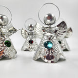 Angelitos de hojalata con canica de vidrio