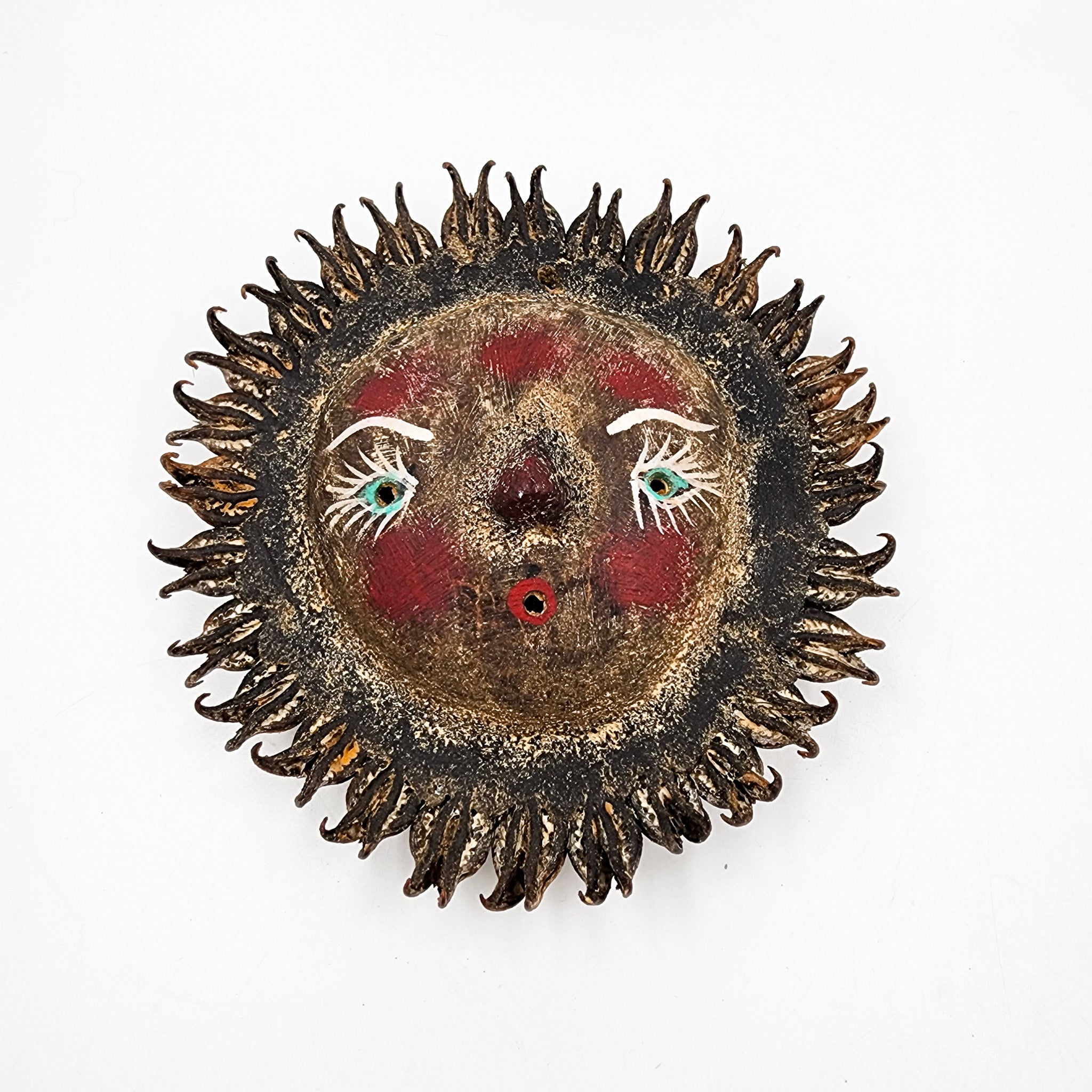 Sun mask made of coconut and seeds as rays