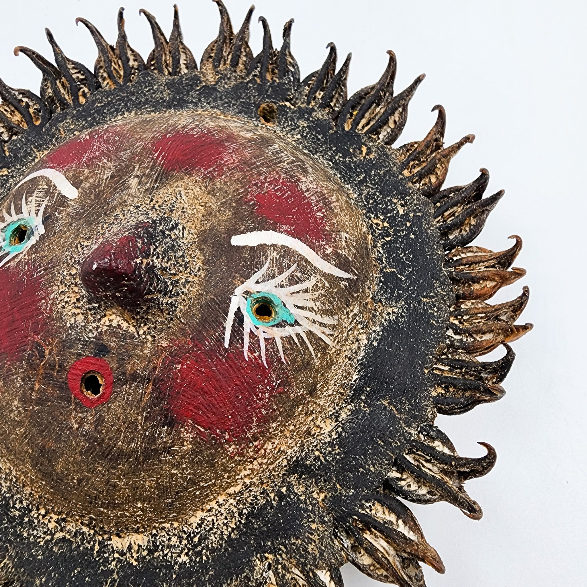 Sun mask made of coconut and seeds as rays