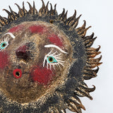 Sun mask made of coconut and seeds as rays