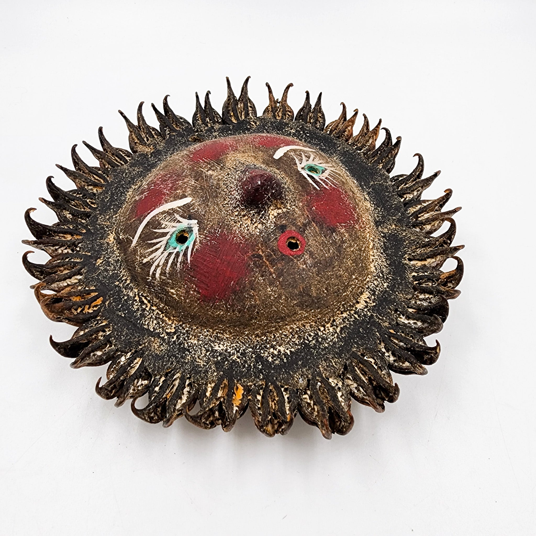 Sun mask made of coconut and seeds as rays