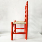 Silla artesanal naranja de madera y palma