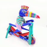 Tucán en bicicleta — Talla de madera alebrije