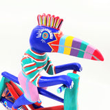Tucán en bicicleta — Talla de madera alebrije