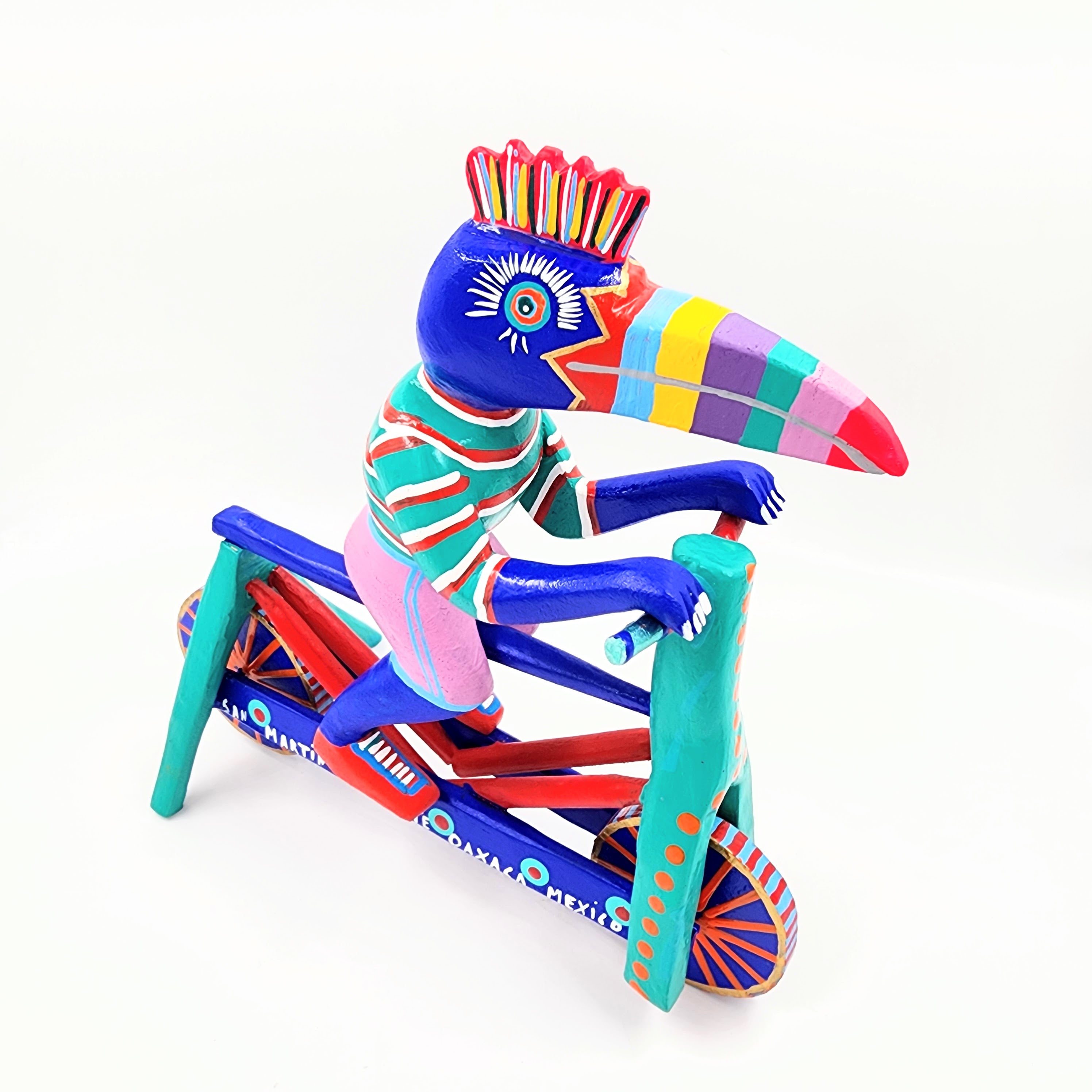 Tucán en bicicleta — Talla de madera alebrije