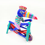 Tucán en bicicleta — Talla de madera alebrije