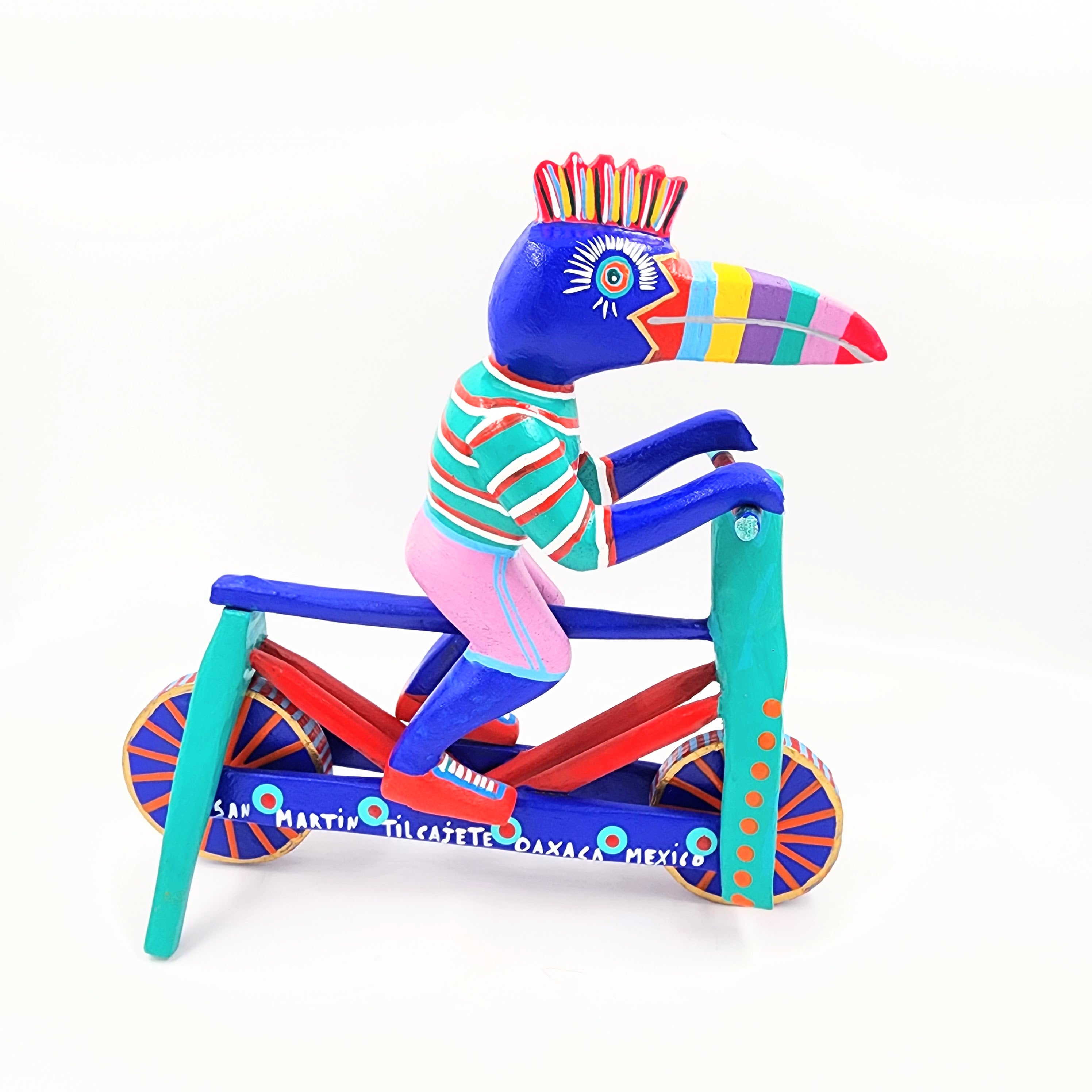Tucán en bicicleta — Talla de madera alebrije
