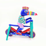 Tucán en bicicleta — Talla de madera alebrije
